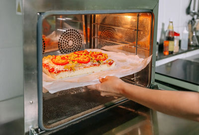 Cropped hand preparing food in kitchen
