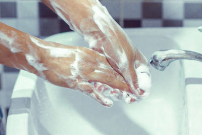 Close-up of human hand in bathroom