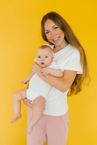 Loving mother takes care of a newborn baby at home. portrait of a happy mother holding a sweet son