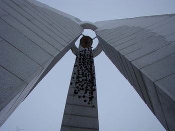 Low angle view of woman standing against sky