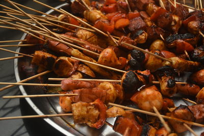 Barbecue with all sorts of frozen food, such as sausage, dumpling, meatballs and peppers