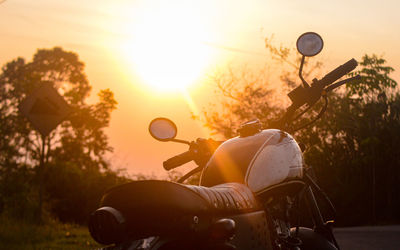 Sunset riding with an old classic motorbike