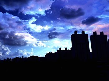 Buildings against cloudy sky