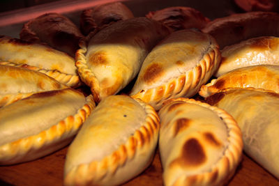 Making pizza and empanadas by chefs in a neighborhood pizzeria in quilmes, argentina.