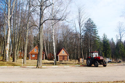 Built structure on field by trees against sky