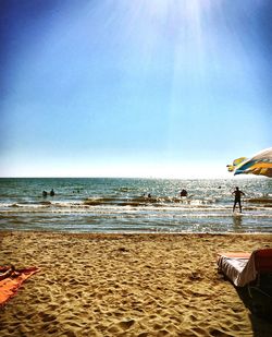 People on beach against sky