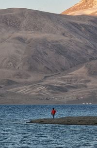 Man standing at sea shore