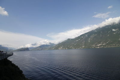 Scenic view of sea and mountains against sky