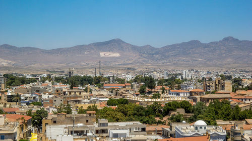 View of town in city against clear sky