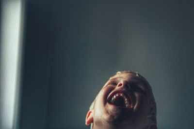 Close-up portrait of toddler laughing
