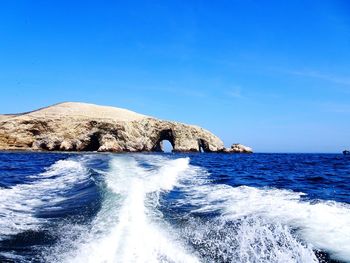 Scenic view of sea against clear blue sky