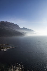 Scenic view of sea and mountains against sky