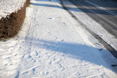 Untreated frozen snow from the sidewalk and street in a residential area in lublin.