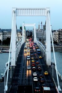 High angle view of vehicles on bridge over river in city