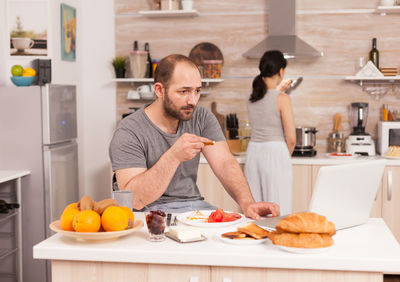 People having food in kitchen