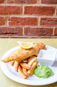 Close-up of food on table against wall