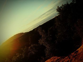 Scenic view of silhouette mountain against sky at sunset