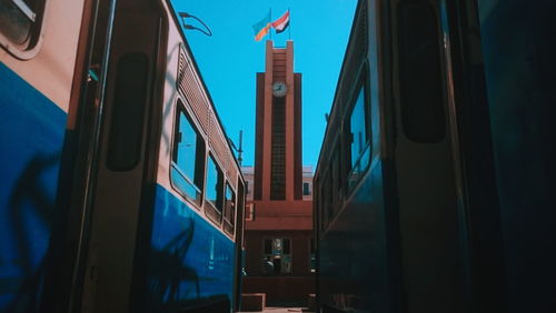 Low angle view of illuminated buildings against blue sky