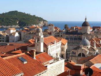 High angle view of town by sea against clear sky