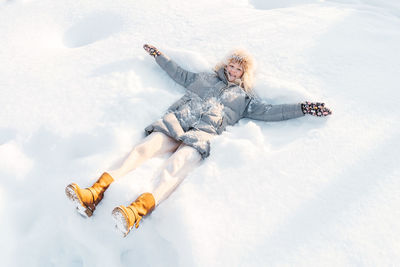 Aerial view of person lying on snow