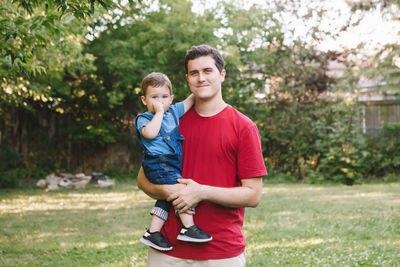 Portrait of boy and son on plant