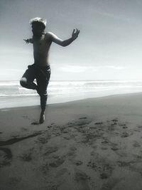 Man standing on beach against sky