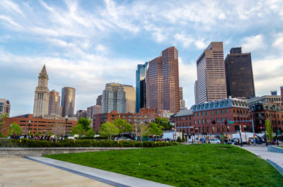 Buildings in city against cloudy sky