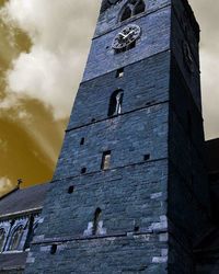 Low angle view of building against cloudy sky