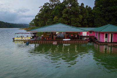 Scenic view of lake by building against sky