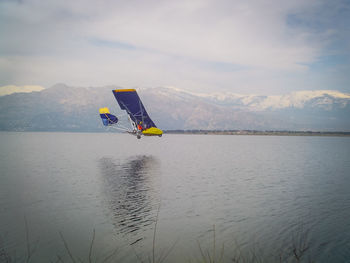 Scenic view of lake against cloudy sky