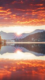 Scenic view of lake against orange sky