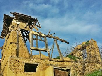 Low angle view of built structure against cloudy sky