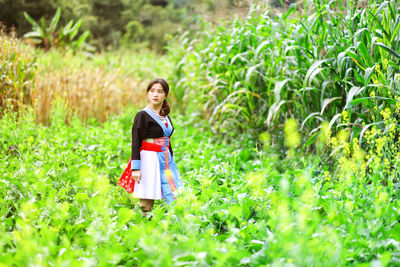 Teenage girl standing on field 