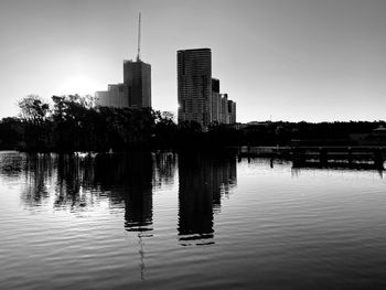 Reflection of buildings in lake against sky
