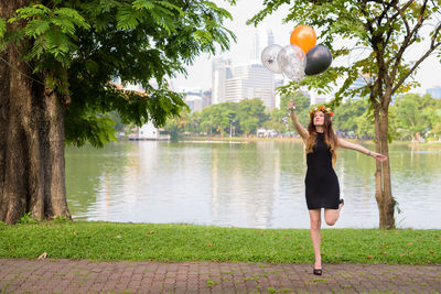 Full length of woman standing by plants