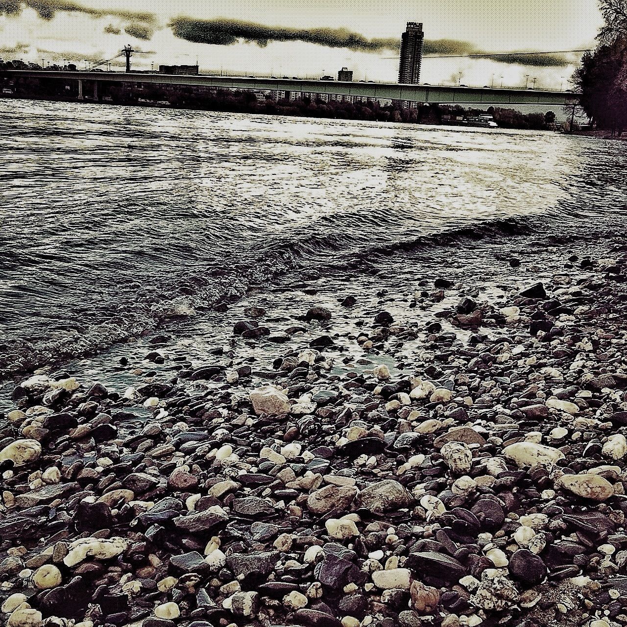 water, built structure, architecture, puddle, surface level, beach, stone - object, day, building exterior, nature, street, outdoors, no people, shore, tranquility, sand, wet, high angle view, road, sky