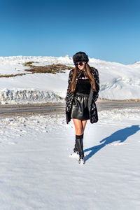 Full length of woman on snow covered landscape