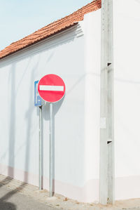 Road sign against wall