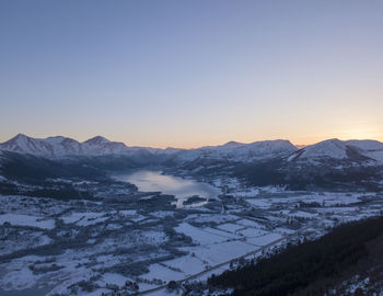 Scenic view of snowcapped mountains against clear sky during winter