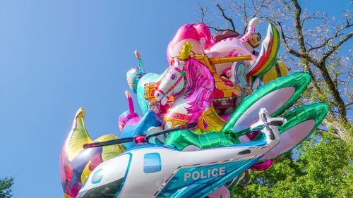 Low angle view of multi colored carousel against sky