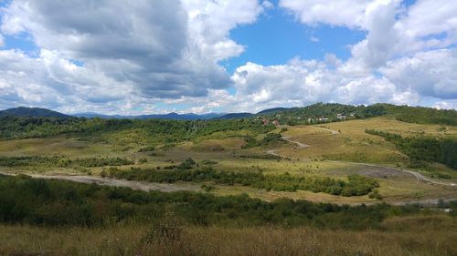 Scenic view of landscape against cloudy sky