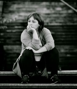 Portrait of cute girl sitting on wall