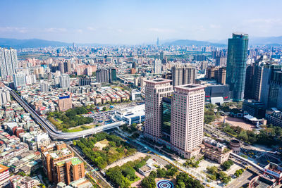 High angle view of modern buildings in city against sky