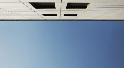 Low angle view of building against clear blue sky