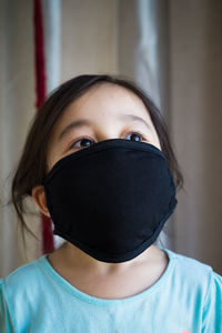 Girl wearing mask at home