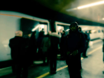 Rear view of people walking in subway