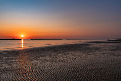 Scenic view of beach against sky during sunset