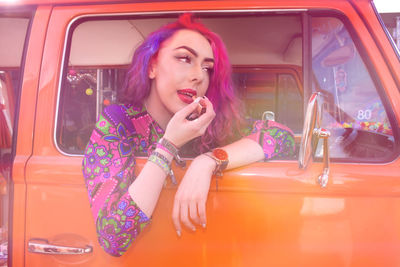 Portrait of beautiful woman sitting in car