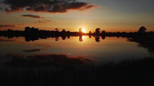 Scenic view of lake against sky during sunset