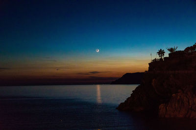 Scenic view of sea against sky at sunset